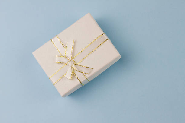 istock small gift on a pastel background, closeup. Gift box with a bow 1234622538