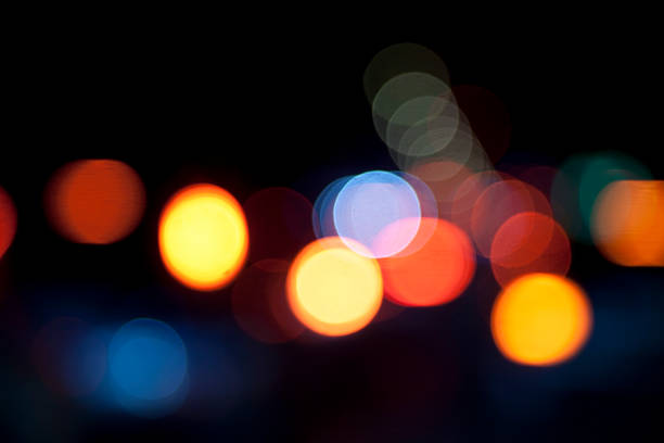 defocused light dots against black background stock photo