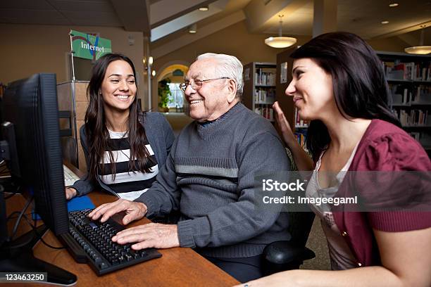 Teaching Grandpa How To Surf The Net Stock Photo - Download Image Now - Library, Volunteer, Computer