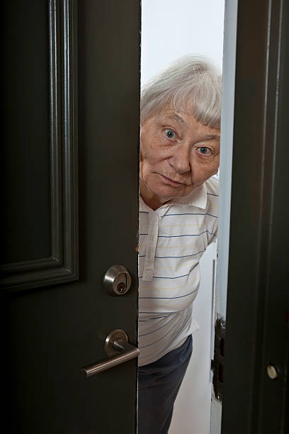 istock Elderly woman opening the front door 123463716