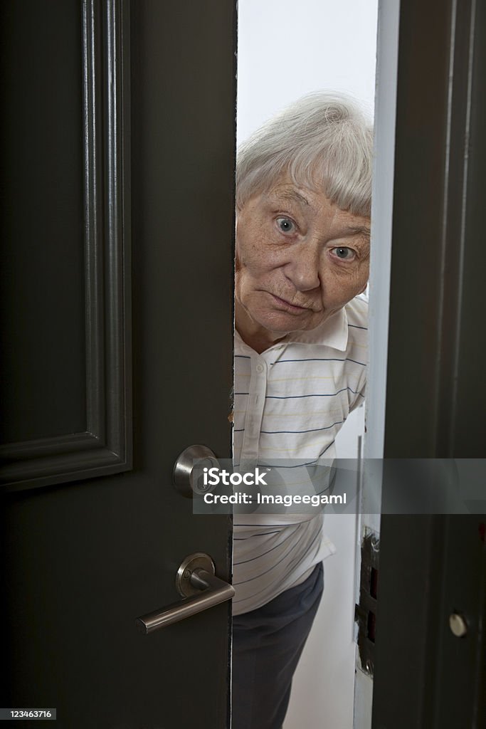 Elderly woman opening the front door Please visit my LIGHTBOX FEATURING THIS MODEL(Just click on the thumbnail): Senior Adult Stock Photo