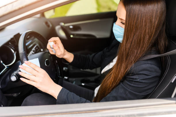 istock Young woman in protective mask is driving car 1234641685