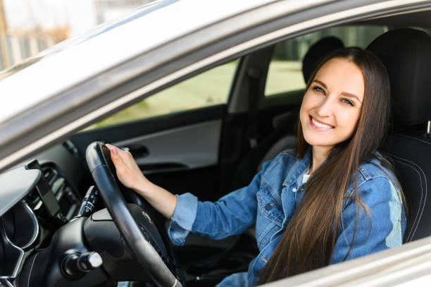istock A young woman is driving a car 1234641707