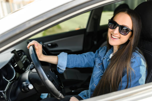 istock A young woman is driving a car 1234641713