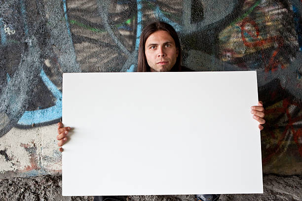 istock Homeless man holding a blank sign 123464264