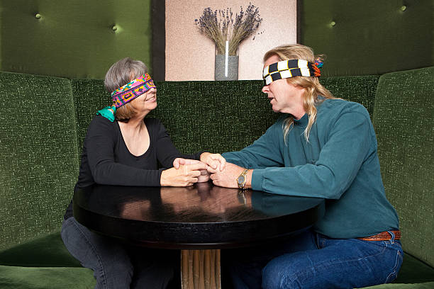 Blind Date Couple getting to know each other on a blind date. blind date stock pictures, royalty-free photos & images