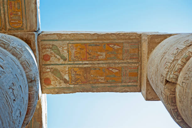 Hieroglypic carving and paintings on ceiling wall at the ancient egyptian Karnak temple in Luxor with columns