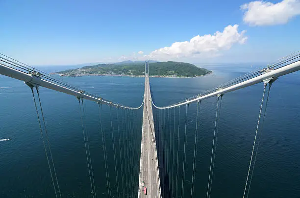 Akashi Kaikyo Bridge in Kobe, Japan looking towards Awaji. Viewed from nearly 300 meters up towards the central span, the longest in the World.