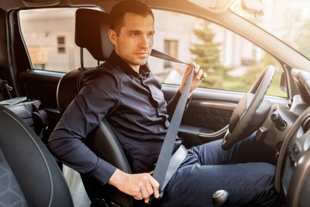 istock Safety driving concept. A man fastens his seat belt. Before driving 1234748125