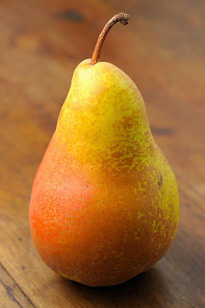 Single Ripe Pear Fruit on Old Brown Wood