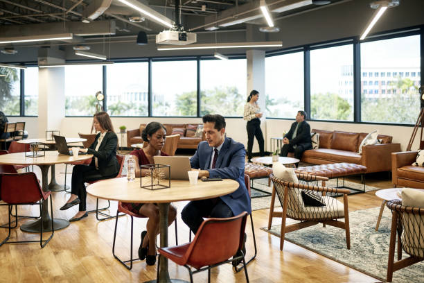 istock Male and Female Executives Working in Open Plan Office 1234776258