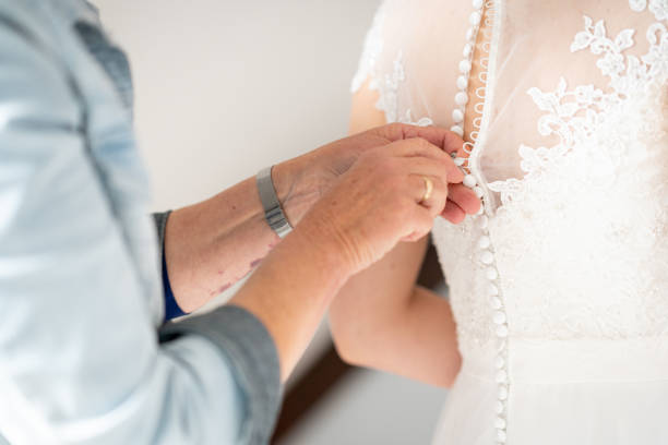 istock Mother hands buttoning wedding dress 1234779415