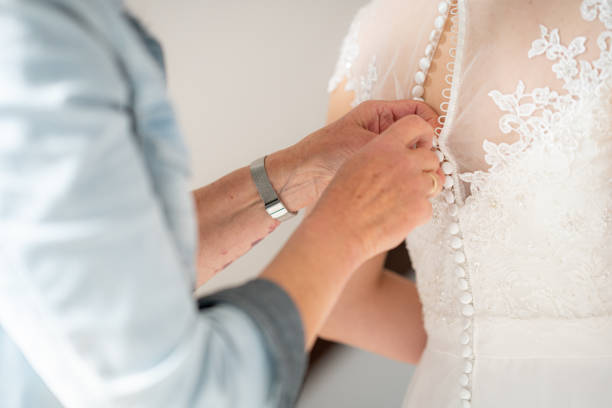istock Mother hands buttoning wedding dress 1234782665