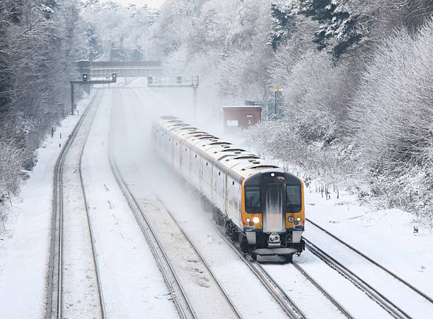 Train transporting commuters in winter snow and ice to London