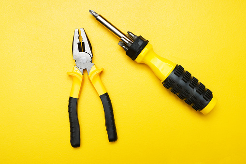 Yellow working tools pliers and screwdriver