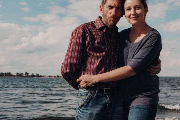 istock Loving couple with age difference rest on river bank 1234898884