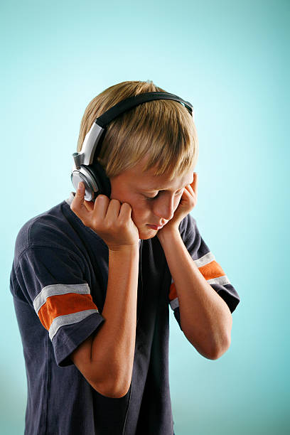istock boy listening with headphones 123493494
