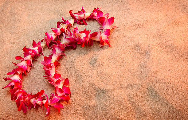 Child girl holding sand make heart shape in hands and playing on the beach in summer vacation