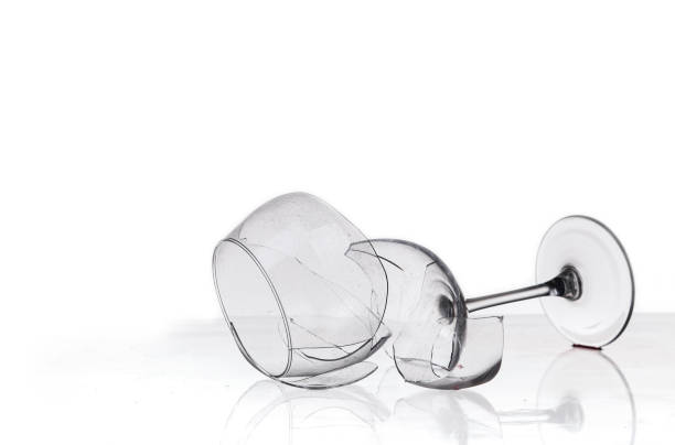 istock broken wine glass on a quilted table on white background 1234938538