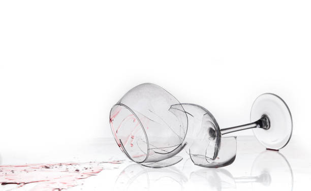 istock broken wine glass on a quilted table on white background 1234939052