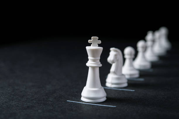 istock Chess pieces on a dark background with constraint lines 1234940629