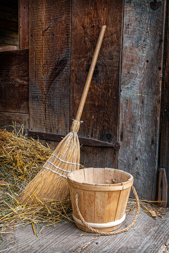 Vintage Broom and Bucket in rural setting suggesting days gone by.