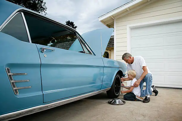 Photo of Father and son changing a tire