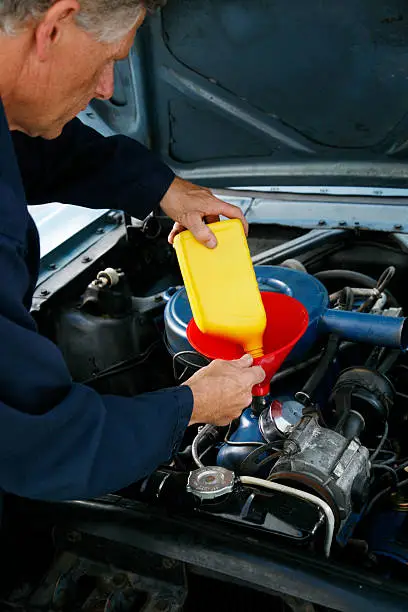 Photo of auto mechanic changing the oil