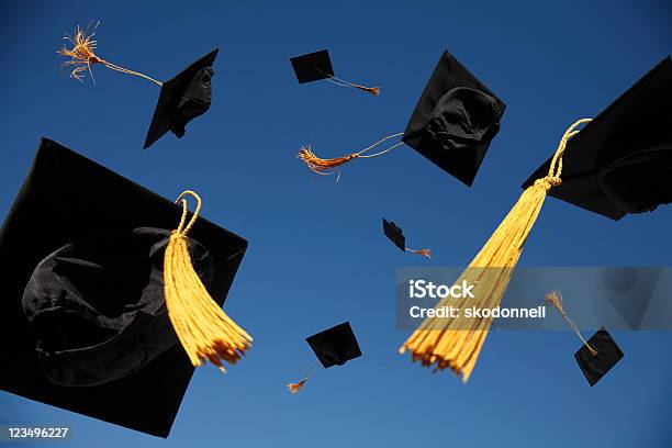 Graduation Caps Thrown In The Air Stock Photo - Download Image Now - Graduation, Mortarboard, University