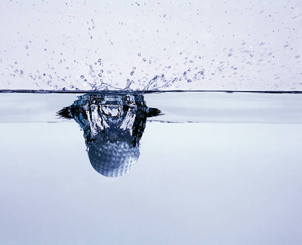 324.Close-up of water droplet splash forming a crown shape mid-air. Ripples and bubbles spread across surface. Warm lighting highlights fluid motion, reflections, and dynamic texture.