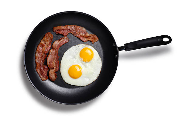 Bacon and eggs in a frying pan  cooking pan overhead stock pictures, royalty-free photos & images