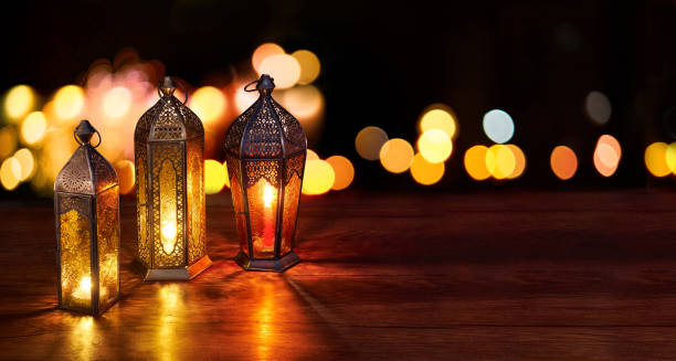 istock Ramadan lanterns on the table. Dark background with street light and bokehs. Beautiful Greeting Card with copy space for Ramadan and Muslim Holidays. An illuminated Arabic lamp. Mixed media. 1234975201