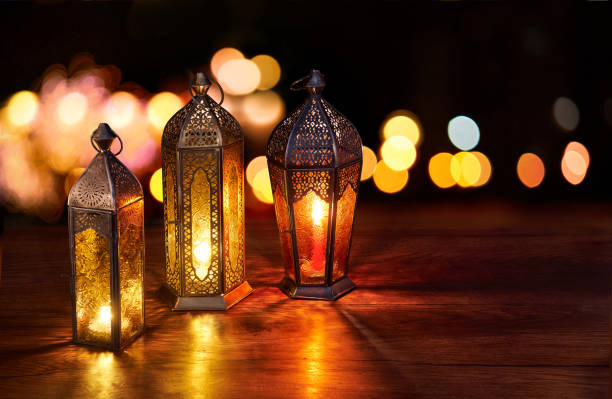 istock Ramadan lanterns on the table. Dark background with street light and bokehs. Beautiful Greeting Card with copy space for Ramadan and Muslim Holidays. An illuminated Arabic lamp. Mixed media. 1234976218