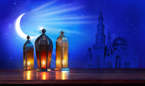 istock Ramadan lanterns on the table with moon and mosque on dark blue background. Beautiful Greeting Card with copy space for Muslim Holidays. An illuminated Arabic lamp. Mixed media. 1234977234