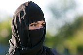 Portrait of a muslim woman in black clothes.
