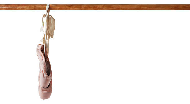 Pair of ballerina pointe shoes over colored background