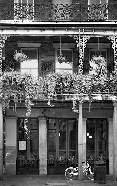 french quarter in new orleans - bicycle ornamental garden flower formal garden stock-fotos und bilder