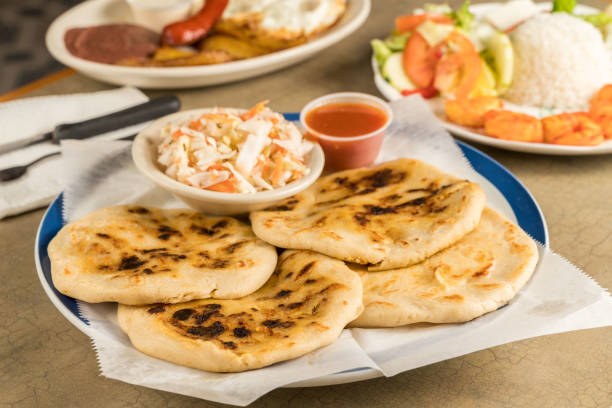 a dish of pupusas  and others mexican food on the table - guacamole avocado mexican culture food imagens e fotografias de stock