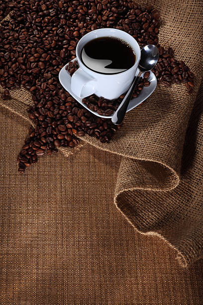 istock Cup of Coffee on a Table with Beans 123501744