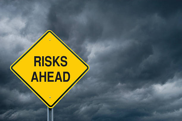 istock Yellow risks ahead caution sign in front of storm clouds 123503217