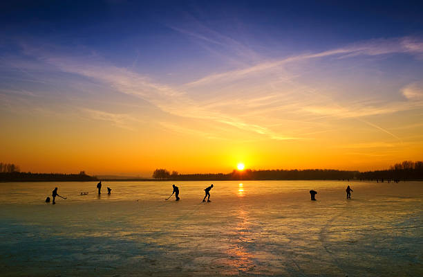 istock ice skating on a frozen lake at sunset 123504305