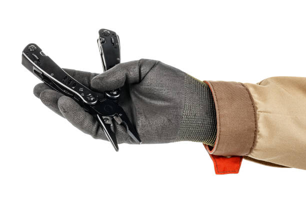 istock Man hand in black protective glove and brown uniform holding multi tool knife isolated on white background 1235050715