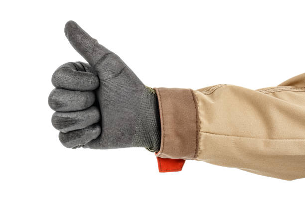 istock Worker hand in black protective glove and brown uniform showing a thumb-up gesture isolated on white background 1235050716