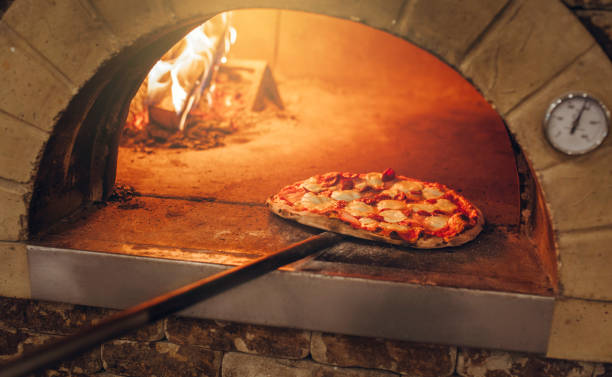 istock Italian pizza is cooked in a wood-fired oven. 1235055397