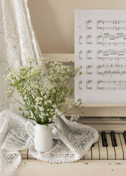 istock bouquet wildflowers on white piano with notes. Retro photo 1235083853