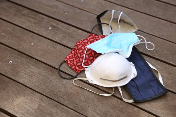 istock Various medical face masks on a wooden table. 1235084361