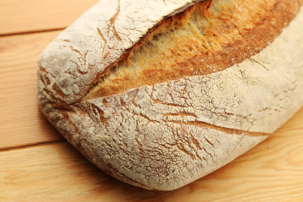 istock Freshly baked ciabatta bread on a wooden board. 1235085391