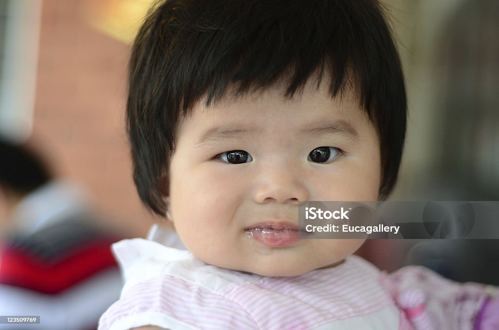 Baby smirk An Asian baby making face at the camera. Baby - Human Age Stock Photo