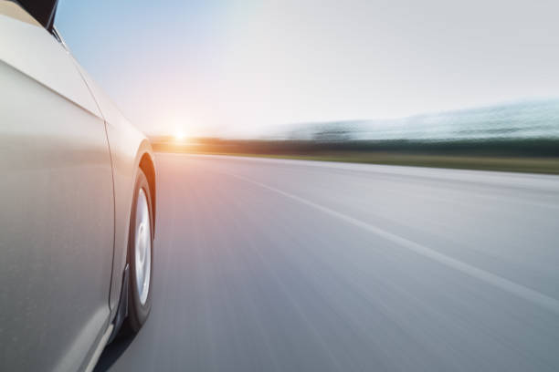istock speeding car with blurred road 1235110530