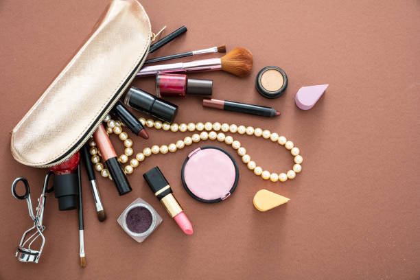 istock Make-up cosmetic bag against brown background, copy space 1235149803